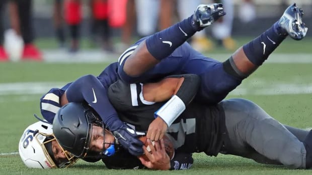 Bishop Sycamore’s quarterback is tackled by a defender from Archbishop Hoban.